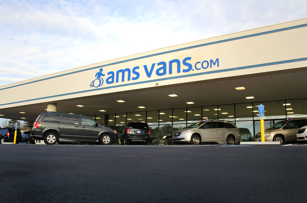 AMS Vans Building with Wheelchair Vans in Front